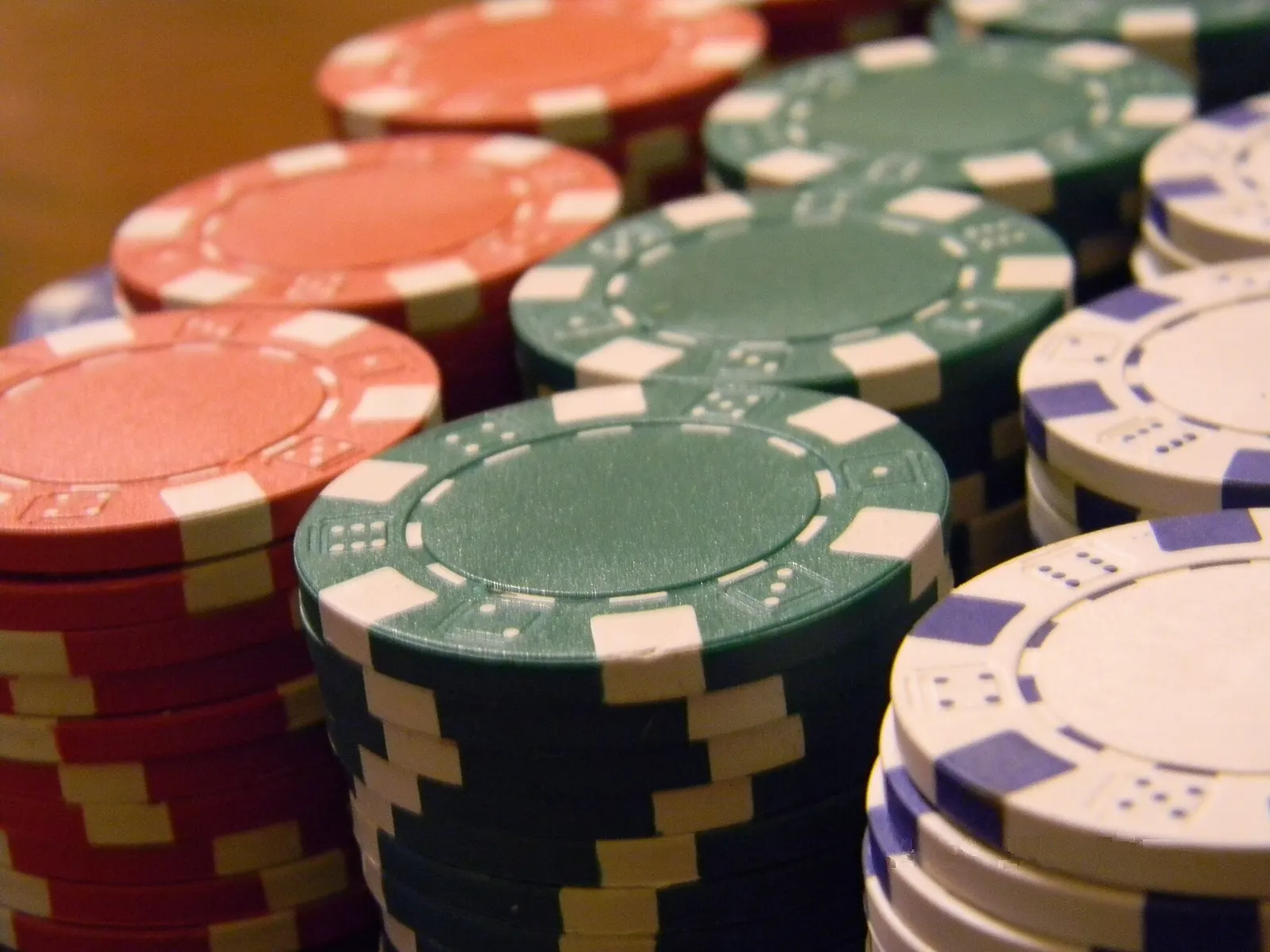 Close-up of stacked poker chips in red, green, white and blue.